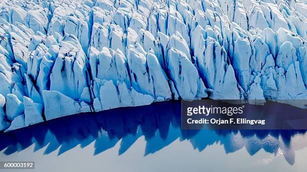 The Knik Glacier in Alaska. Lack of snow-cover expose the ash fallout from the nearby Redoubt Volcano, reducing the albedo effect. There are...