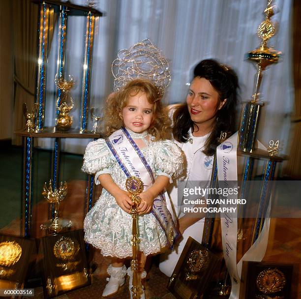 Beauty show winner and mother with trophies.