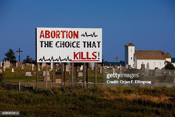 Superboard with the text " Abortion - the choice that kills" is placed inside a cemetary in Kimball. | Location: Kimball, South Dakota, USA.