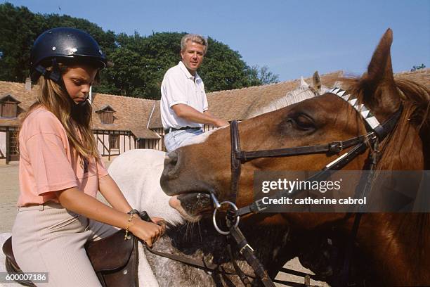Athina Onassis Roussel, grand-daughter of Greek shipping magnate Aristotle Onassis riding with her father, French businessman Thierry Roussel.