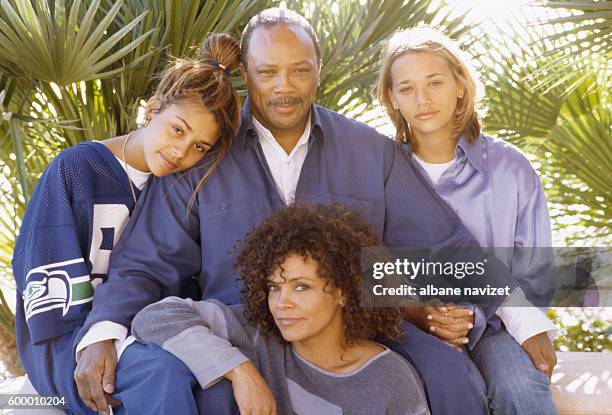 American composer and producer Quincy Jones relaxes with his three daughters, Jolie, Kidada and Rashida.