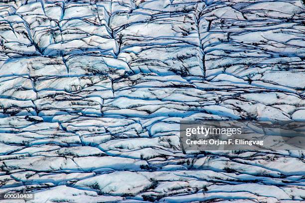 The Knik Glacier in Alaska. Lack of snow-cover expose the ash fallout from the nearby Redoubt Volcano, reducing the albedo effect. There are...