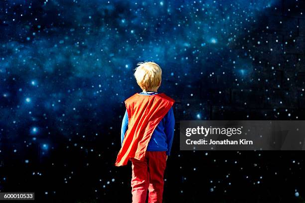 young super hero against a field of stars. - superman reveal stock pictures, royalty-free photos & images