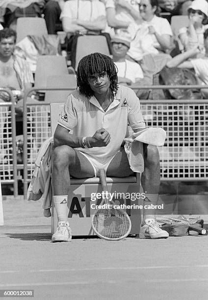 Tennis player Yannick Noah takes a break during the 1983 Monte-Carlo tennis championships.