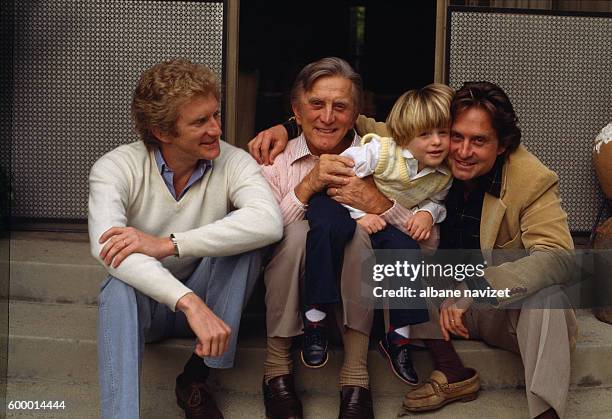 American actor Kirk Douglas relaxes with sons actors Michael Douglas and Peter Douglas, and his grandson, Cameron .