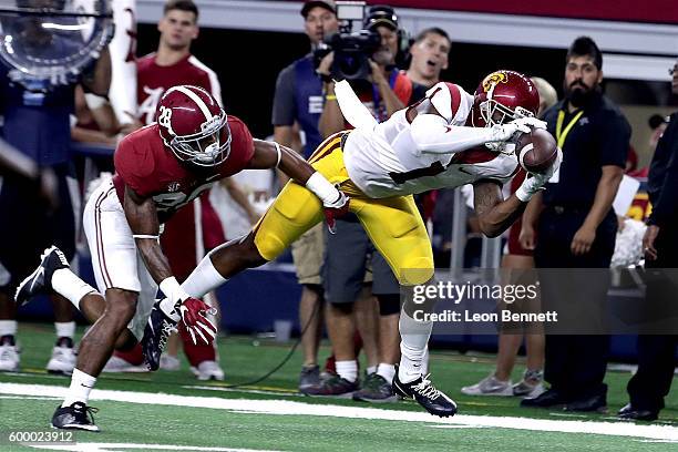 Darreus Rogers of the USC Trojans catches a pass against Anthony Averett of the Alabama Crimson Tide in the second quarter during the AdvoCare...