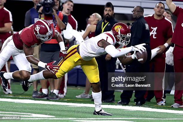 Darreus Rogers of the USC Trojans catches a pass against Anthony Averett of the Alabama Crimson Tide in the second quarter during the AdvoCare...