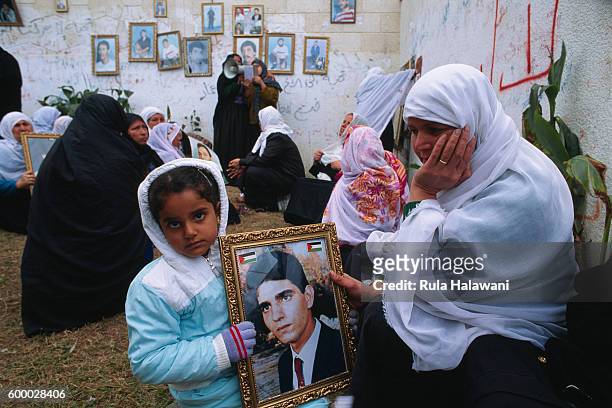 Women parade photos of their sons, martyrs of the Intifada.