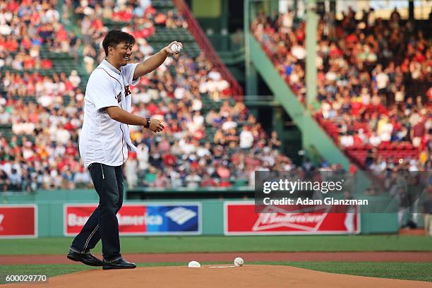 Former Boston Red Sox pitcher Hideki Okajima throws out a ceremonial first pitch before a game against the New York Yankees on August 11, 2016 at...