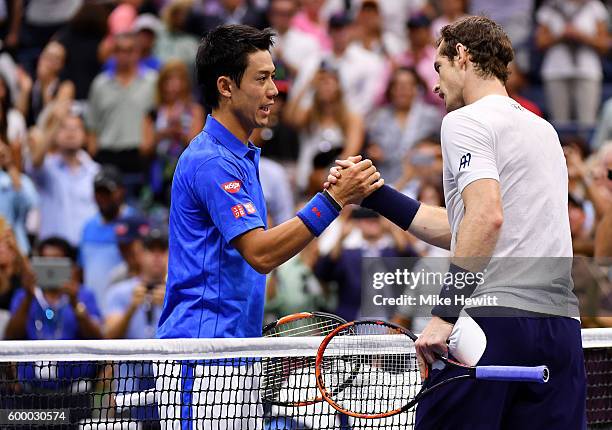 Kei Nishikori of Japan shakes hands with Andy Murray of Great Britain after defeating him during their Men's Singles Quarterfinal match on Day Ten of...