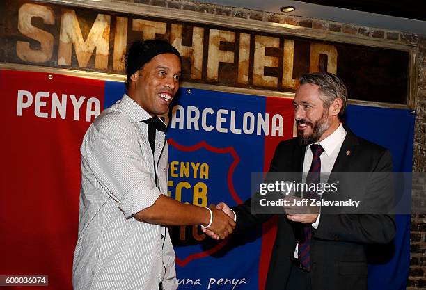 Ronaldinho is greeted by Jordi Getman-Eraso, President of Penya FC Barcelona New York City at Smithfield Hall on September 7, 2016 in New York City.