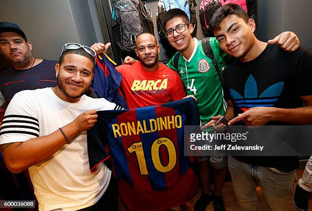 Barcelona fans pose for pictures at Niketown to celebrate the Club's arrival to New York on September 7, 2016 in New York City.