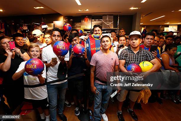 Barcelona fans pose for pictures at Niketown to celebrate the Club's arrival to New York on September 7, 2016 in New York City.