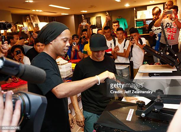 Ronaldhino creates a customized jersey as FC Barcelona fans gather at Niketown to celebrate the Club's arrival to New York on September 7, 2016 in...
