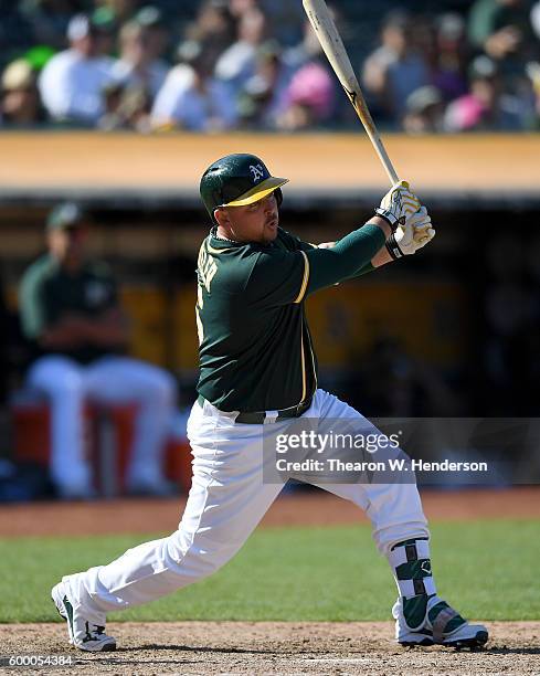 Billy Butler of the Oakland Athletics bats against the Los Angeles Angels of Anaheim in the bottom of the eighth inning at Oakland-Alameda County...