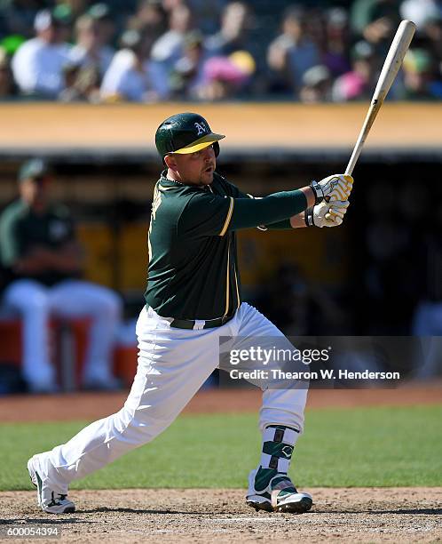 Billy Butler of the Oakland Athletics bats against the Los Angeles Angels of Anaheim in the bottom of the eighth inning at Oakland-Alameda County...