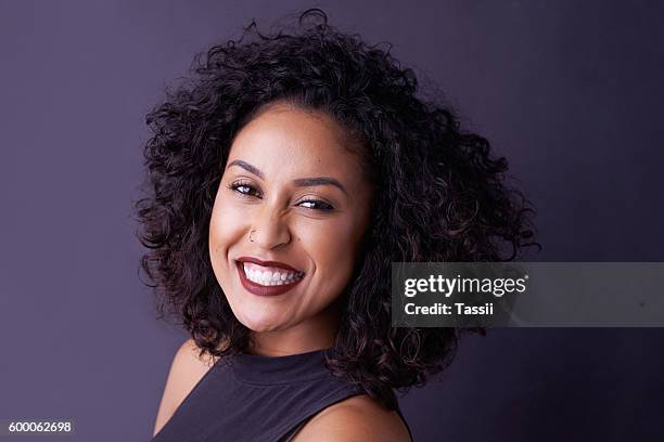 curly hair equals big personality - woman on plain background stock pictures, royalty-free photos & images