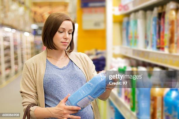 pregnant woman buys washing powder - detergent powder stock pictures, royalty-free photos & images