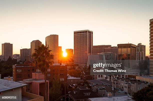 sunset over oakland skyline - oakland stock pictures, royalty-free photos & images