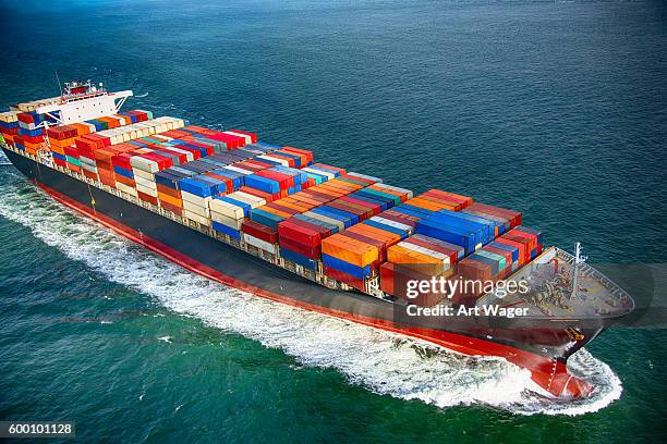 sea bearing cargo ship - cargo container stock pictures, royalty-free photos & images