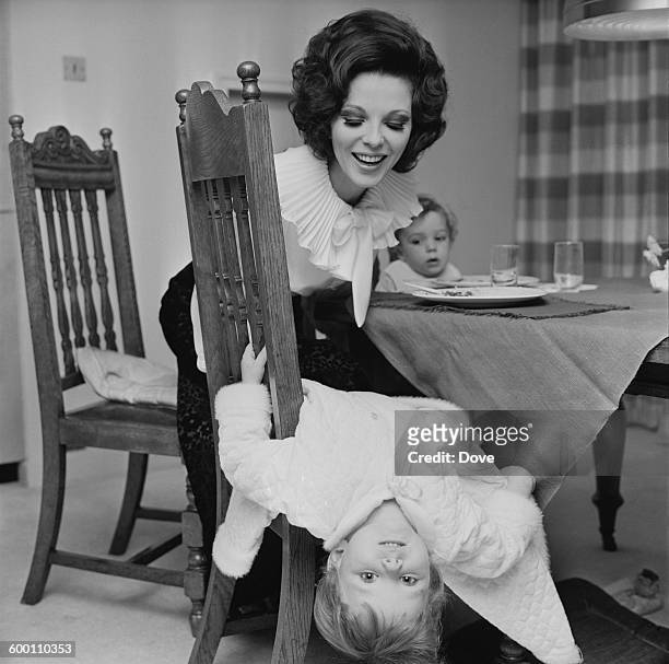 English actress Joan Collins, the wife of actor and singer Anthony Newley, with their two children Tara and Sacha, UK, 18th November 1967.