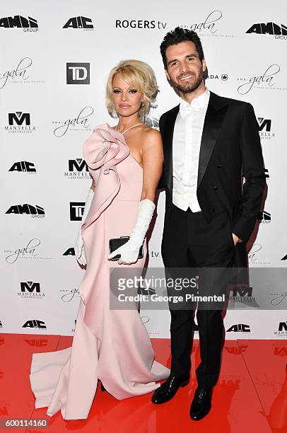 Pamela Anderson and AMBI Pictures co-founder Andrea Iervolino attend the 2016 Toronto International Film Festival 'AMBI Gala' at Ritz Carlton on...