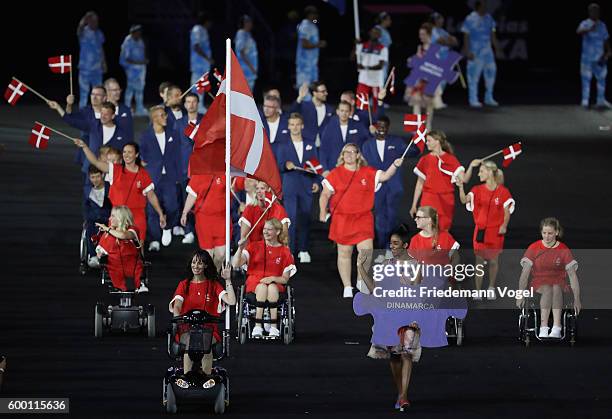 Flag bearer Annika Lykke Dalskov Risum of Denmark leads the team entering the stadium during the Opening Ceremony of the Rio 2016 Paralympic Games at...