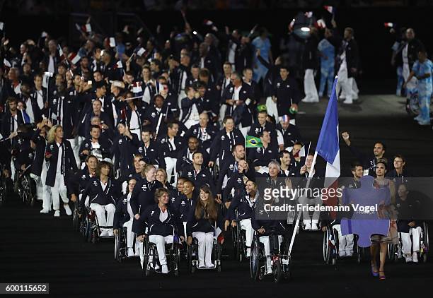 Flag bearear Michael Jeremiasz of France leads the team entering the stadium during the Opening Ceremony of the Rio 2016 Paralympic Games at Maracana...