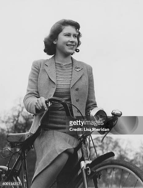 Princess Elizabeth cycling at the Royal Lodge in Windsor, UK, 4th April 1942.