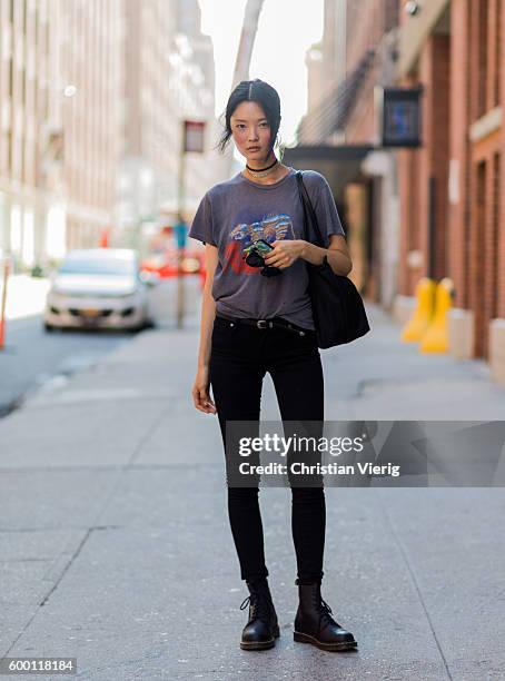 Model Somin Park wearing a tshirt, black denim jeans and Dr. Martens boots outside Parsons on September 7, 2016 in New York City.