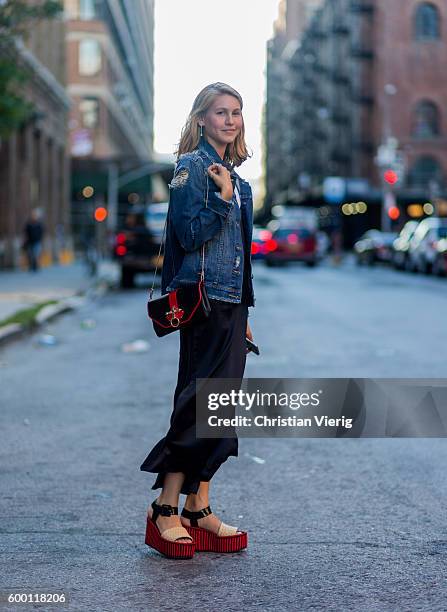 Jessica Minkoff wearing a denim jacket, Givenchy bag, black dress and platform sandals outside R13 on September 7, 2016 in New York City.