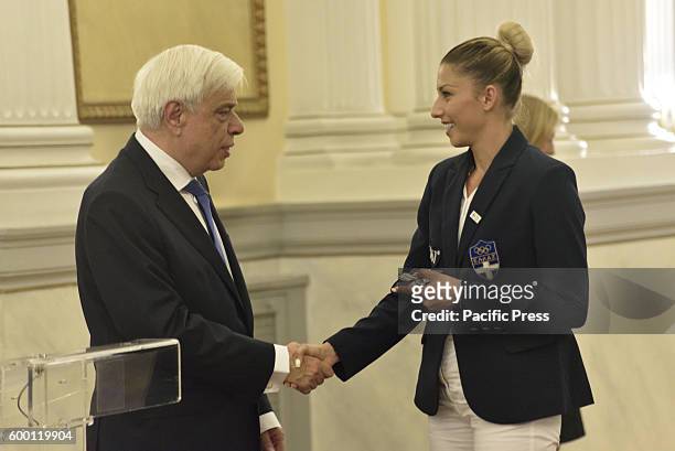 President of Hellenic Democracy Mr. Prokopis Pavlopoulos is offering a souvenir to Papachristou Voula of Athletics in triple jump.