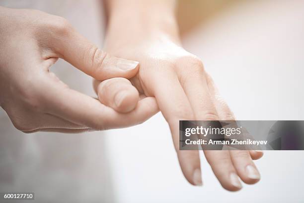 woman making finger and hand massage - druckpunkt stock-fotos und bilder