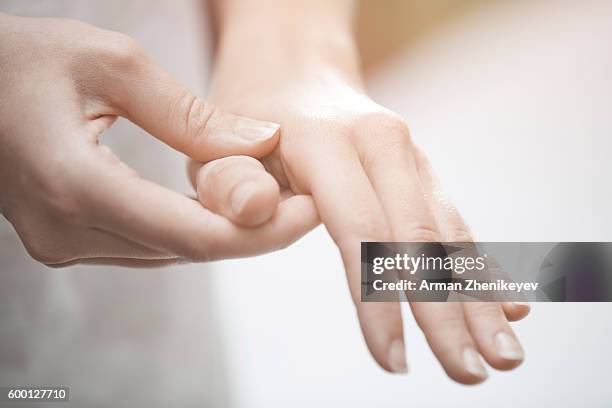 woman making finger and hand massage - se frotter les mains photos et images de collection
