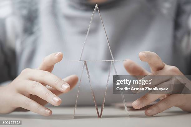 human hands making house of cards - card house stock pictures, royalty-free photos & images