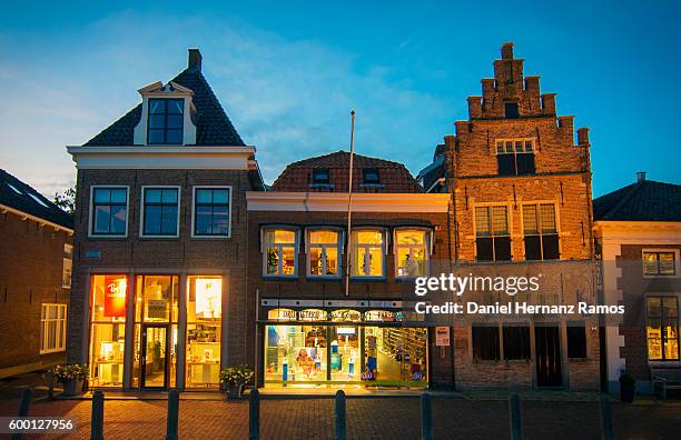 beautiful houses in edam,the netherlands, illuminated at dusk - edamer stock-fotos und bilder