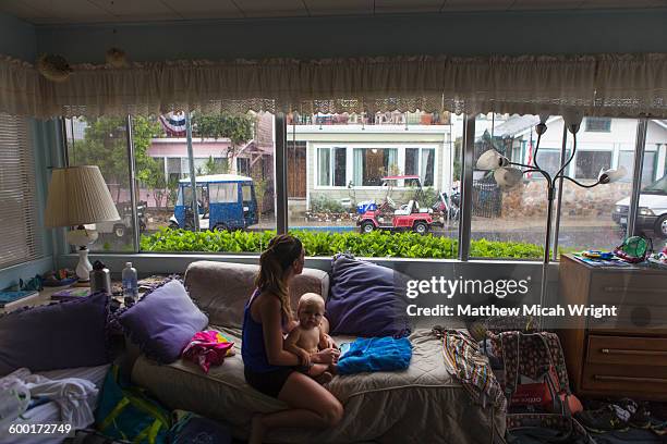 a family takes refuge inside during a storm. - shelter in place concept stock-fotos und bilder