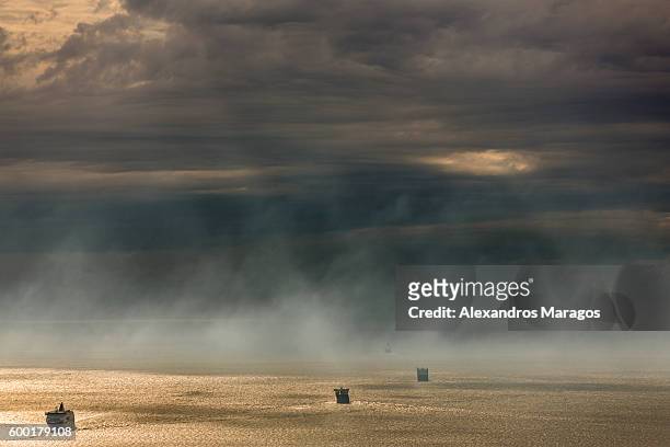 ships in sunset mist - alexandros maragos stock pictures, royalty-free photos & images