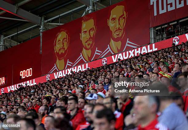 The faces of Wales footballers Joe Allen, Chris Gunter and Ashley Williams on a giant board over the supporters during the 2018 FIFA World Cup...