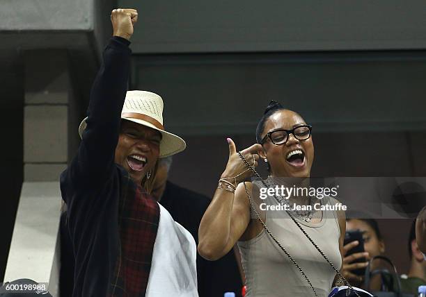 Queen Latifah and Eboni Nichols cheer for their friend Serena Williams during day 10 of the 2016 US Open at USTA Billie Jean King National Tennis...