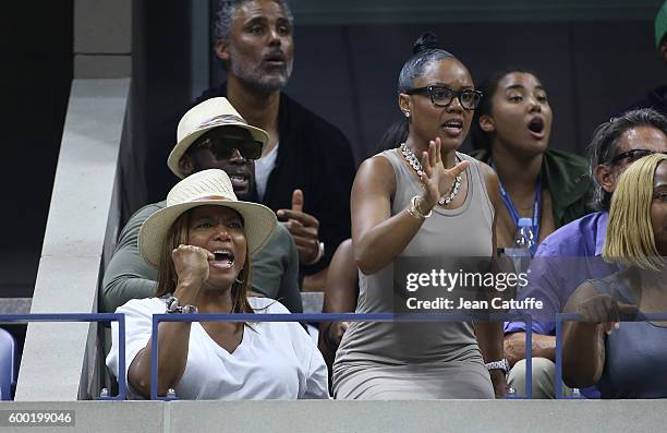 Queen Latifah and Eboni Nichols, above Rick Fox and daughter Sasha Fox cheer for their friend Serena Williams during day 10 of the 2016 US Open at...