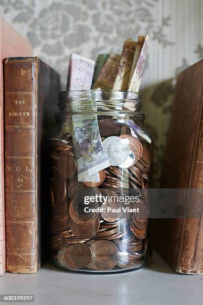 jar of money on mantle piece - mantelpiece stock pictures, royalty-free photos & images