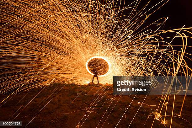 creative light painting by burning steelwool - burning steel wool firework stock pictures, royalty-free photos & images