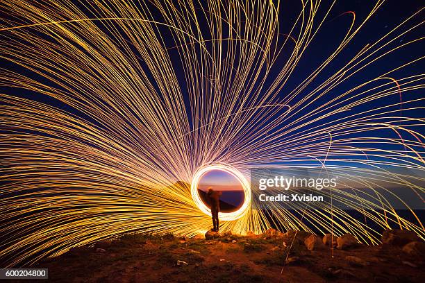 creative light painting by burning steelwool - fire pit stockfoto's en -beelden