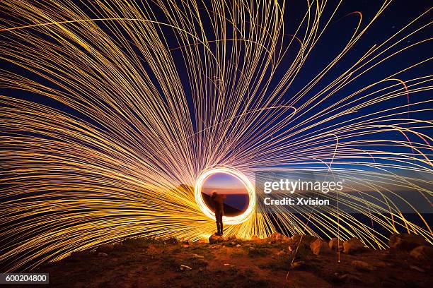 creative light painting by burning steelwool - igniting stock pictures, royalty-free photos & images