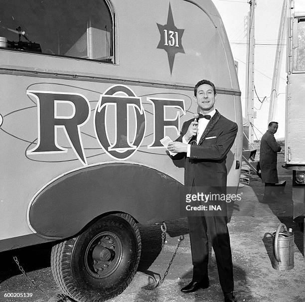 Lucien Jeunesse putting in front of the bearing the initials caravan ORTF during the tour of the Pinder Circus.