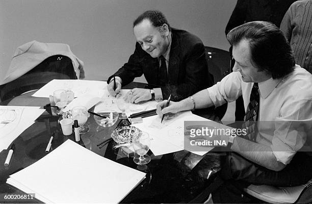 René Goscinny and Albert Uderzo drawing during the recording of the television program "As quick as a flash".