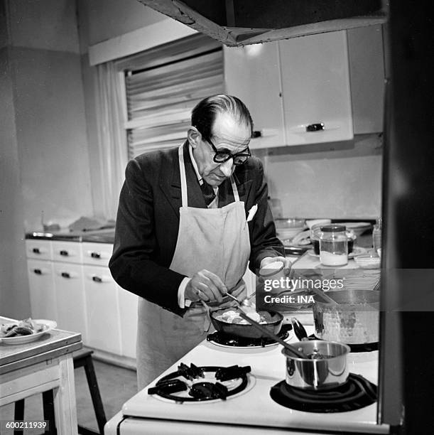 Georges Adet in front of his stoves preparing a recipe.