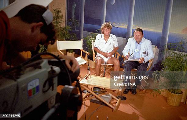In a studio of the stage Roland Garros, the journalist Jean Michel Leulliot gets ready to interview the tennis player Mats Wilander. In the...