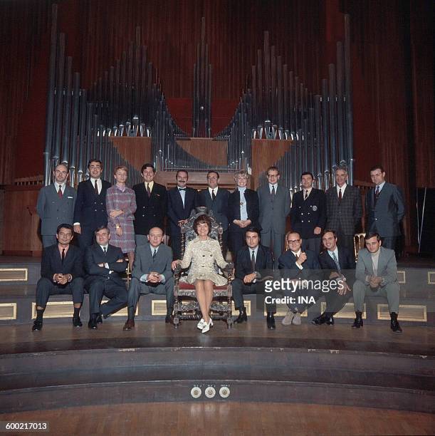 Jacqueline Baudrier, sat on a golden armchair, surrounded with eighteen journalists who are going to liven up the News of the Second channel 24 hours...